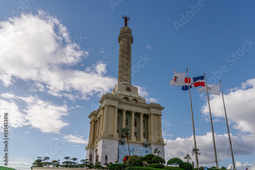 Independence Monument in Santiago against the backdrop of the flag of the Dominican Republic.