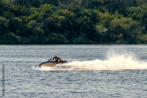 Jet ski driver drift on the river. Spray from a jet ski. photo
