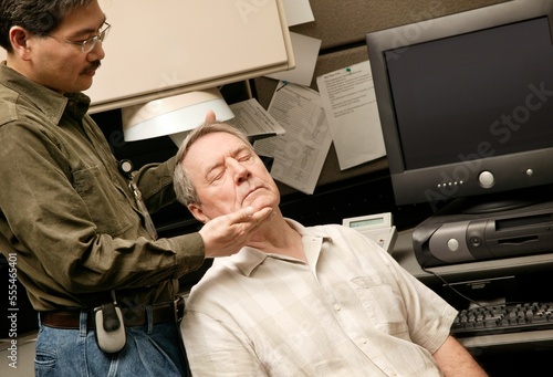 An Occupational Therapist Working With A Senior Businessman photo