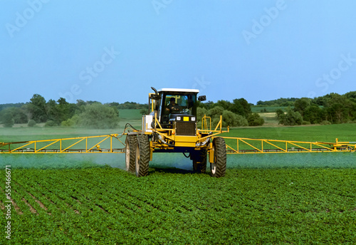 Agriculture - Chemical application of herbicide on a field of early growth soybeans by a RoGator Weed Eater / Hennepin County, Minnesota, USA.