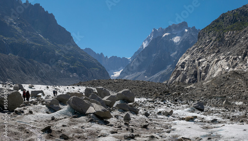 The glacial stream on the glacier Mer de Glace with the Garand Jorasses in the background.