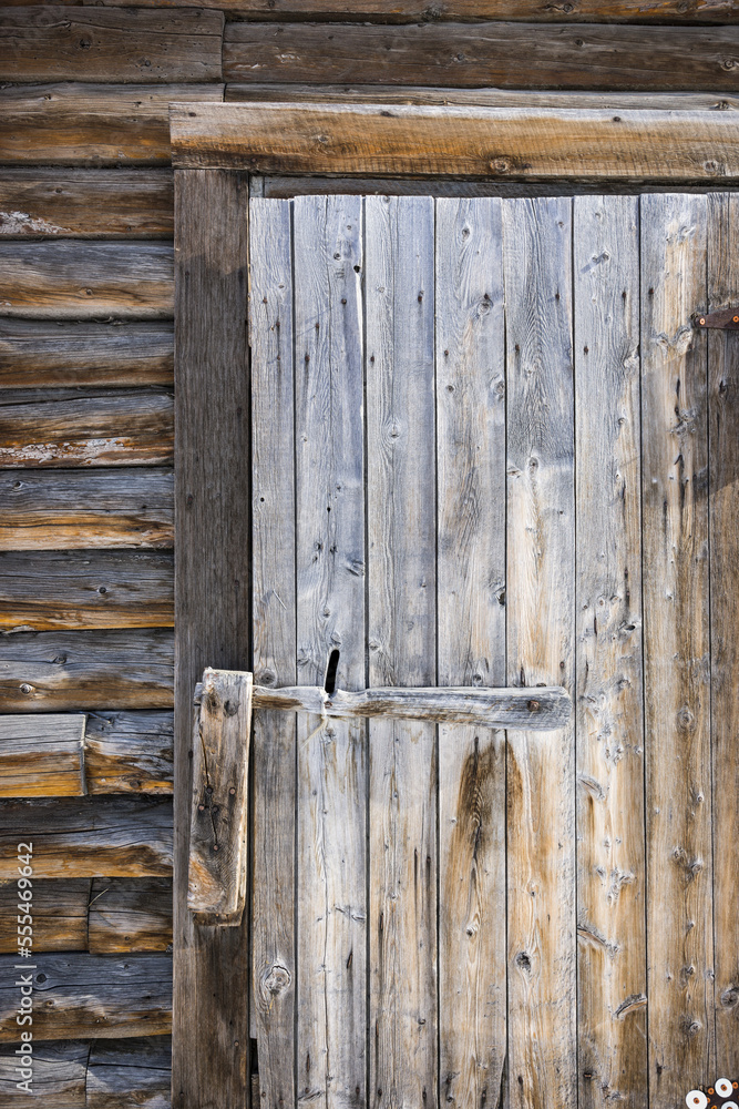 Detail of worn, weathered wooden door and latch, South-central Alaska; Palmer, Alaska, United States of America Detail of worn, weathered wooden door and latch, South-central Alaska; Palmer, Alaska, United States of America