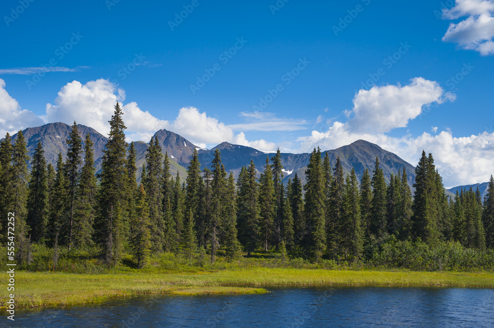 Clouds rolling across mountain peaks in the Talkeetna Range in South-central Alaska on a sunny summer day; Alaska, United States of America Clouds rolling across mountain peaks in the Talkeetna Range in South-central Alaska on a sunny summer day; Alaska, United States of America