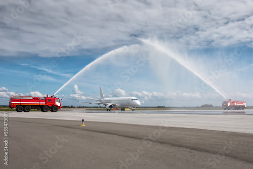 Water arch for first visit white passenger airliner at the airport