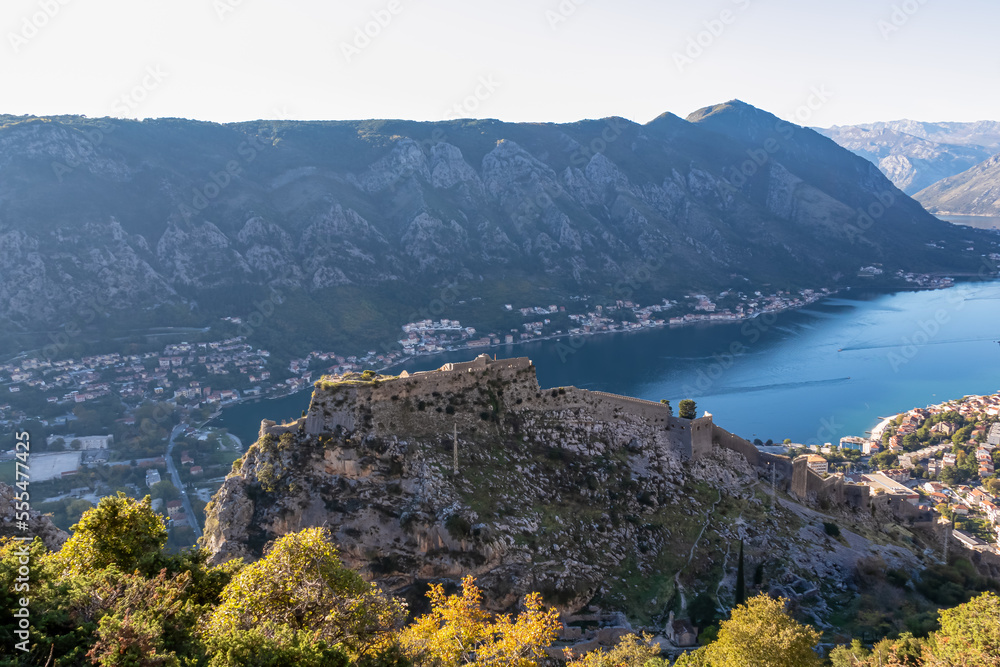 Panoramic view of the Kotor Fortress and bay in summer, Adriatic Mediterranean Sea, Montenegro, Balkan Peninsula, Europe. Fjord winding along coastal towns. Lovcen, Orjen mountain range, Dinaric Alps