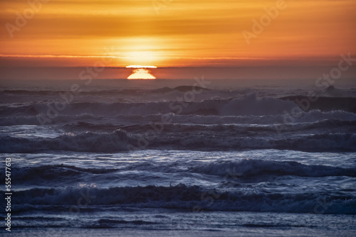 Sunset and waves with Feta Morgana effect photo
