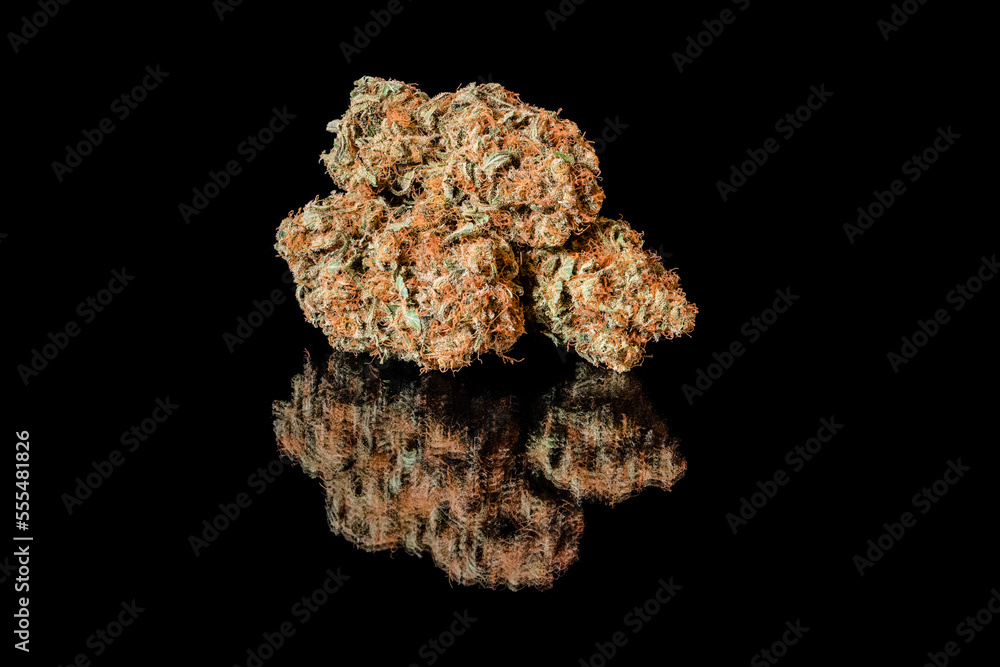 Cannabis flower dried and cured, reflected on a black surface Cannabis flower dried and cured, reflected on a black surface