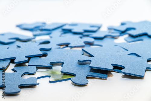 Scattered puzzle pieces on white