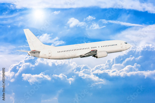 White passenger aircraft fly in the picturesque sky