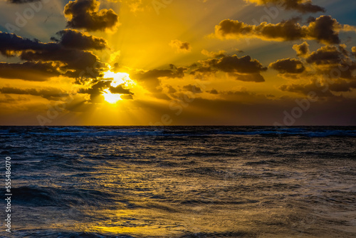 Bright golden sunrise over the Pacific Ocean, viewed from Lydgate Beach; Kapaa, Kauai, Hawaii, United States of America photo