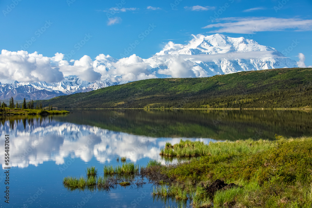 Denali shows well with the blue waters of Wonder Lake, Denali National Park and Preserve; Alaska, United States of America Denali shows well with the blue waters of Wonder Lake, Denali National Park and Preserve; Alaska, United States of America