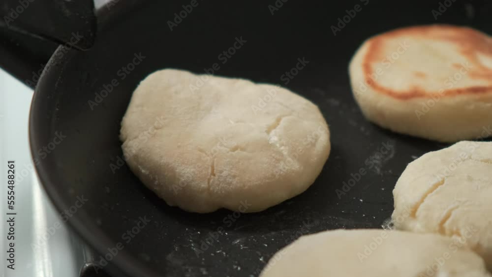 the cook turns over the cheesecakes that are fried in a frying pan. women's hands make syrniki. cheesecakes, syrniki are fried in a frying pan the cook turns over the cheesecakes that are fried in a frying pan. women's hands make syrniki. cheesecakes, syrniki are fried in a frying pan