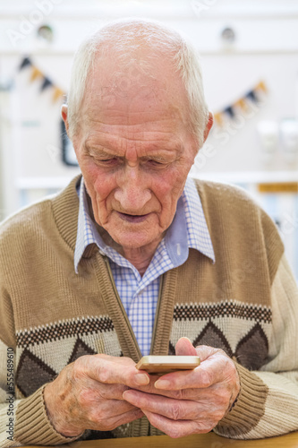 Senior man at the age of 97 with smart phone; Hartlepool, County Durham, England photo