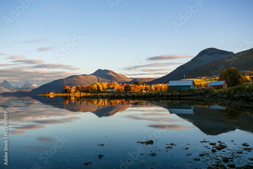  Fishermen`s hut at Arctic bay in Norway with reflection, Balsfjord, Lofoten, Norway