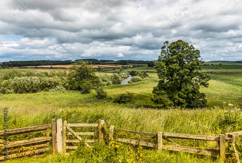 The River Till running through the fields near Crookham Village; Northumberland, England photo