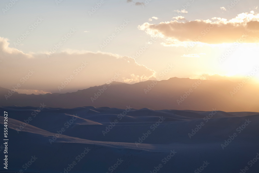 Sun setting on gypsum dunes at White Sands National Monument; Amalogordo, New Mexico, United States of America Sun setting on gypsum dunes at White Sands National Monument; Amalogordo, New Mexico, United States of America