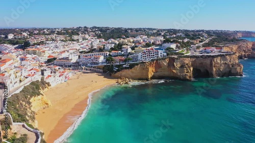 Beautiful aerial views of the seaside tourist town of Carvoeiro with cliff beaches and traditional Portuguese houses.