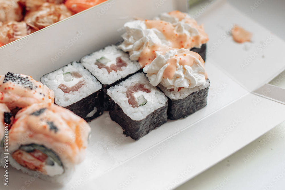 Beautiful delicious sushi. Sushi delivery. Advertising sushi rolls made of fish and cheese. Beautiful delicious sushi. Sushi delivery. Advertising sushi rolls made of fish and cheese.