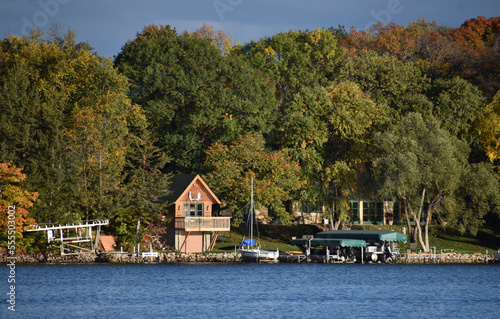 cloudy blue sky over a peaceful minnesota lake shore
