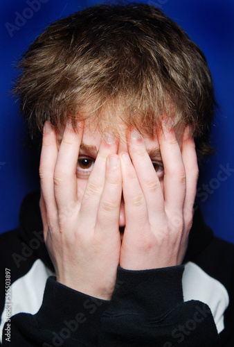 Teenage Boy Covering His Face photo