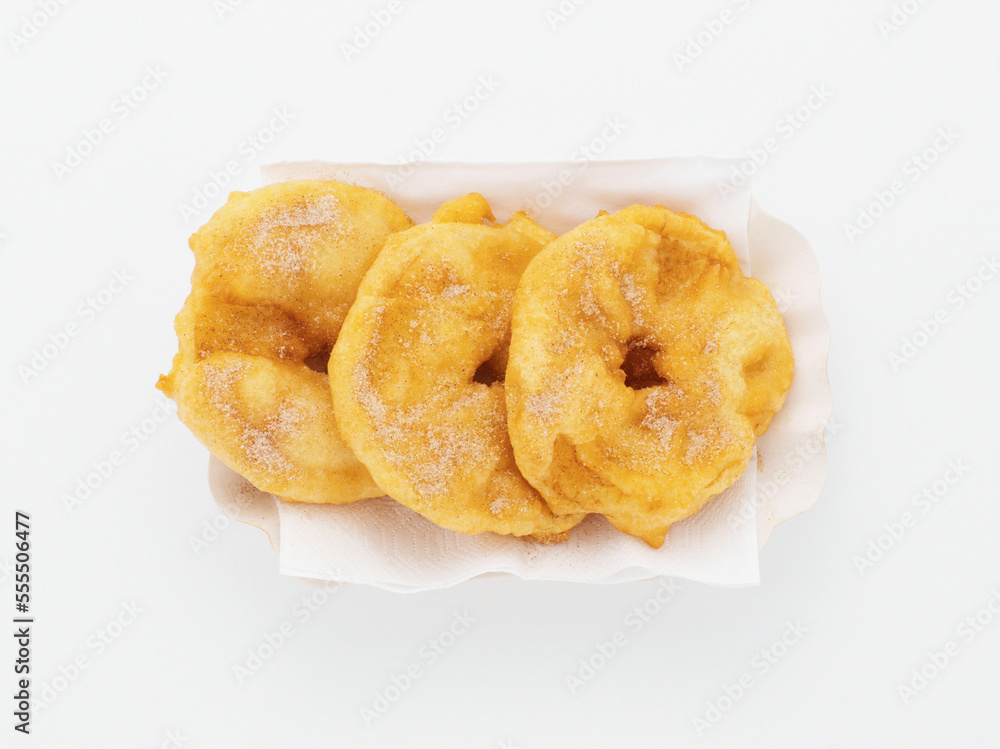 Baked apple slices on paper plate, white background, studio shot Baked apple slices on paper plate, white background, studio shot