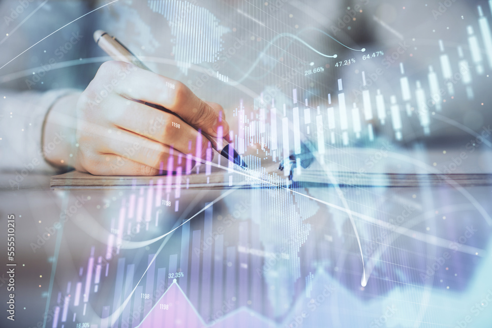 Hands writing information about stock market in notepad. Forex chart holograms in front. Concept of research. Multi exposure Hands writing information about stock market in notepad. Forex chart holograms in front. Concept of research. Multi exposure