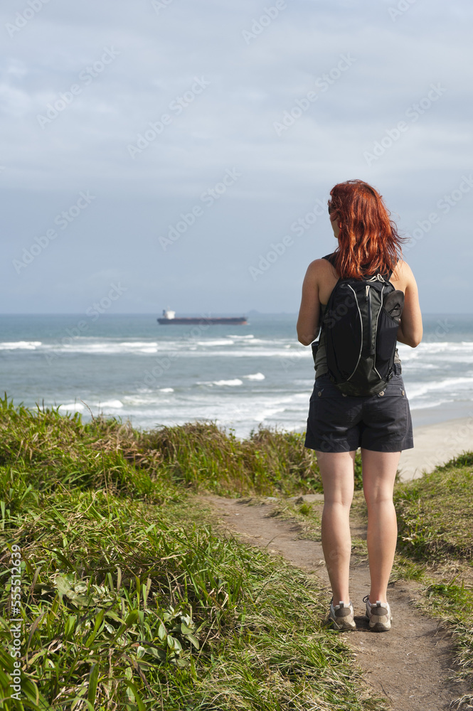 Backview of Woman Hiking and Looking at View, Ilha do Mel, Parana, Brazil Backview of Woman Hiking and Looking at View, Ilha do Mel, Parana, Brazil