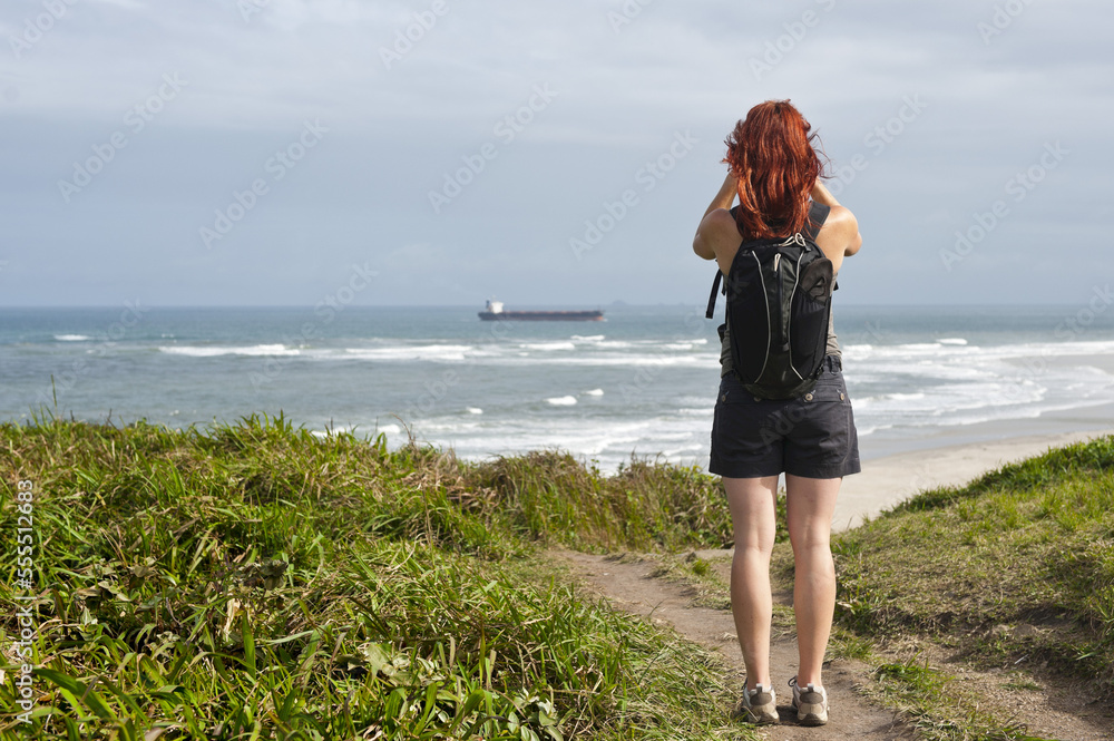 Backview of Woman Hiking and Looking at View, Ilha do Mel, Parana, Brazil Backview of Woman Hiking and Looking at View, Ilha do Mel, Parana, Brazil