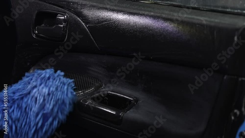 close-up male hands are engaged in cleaning the interior of the car, restoration, dry cleaning, foam