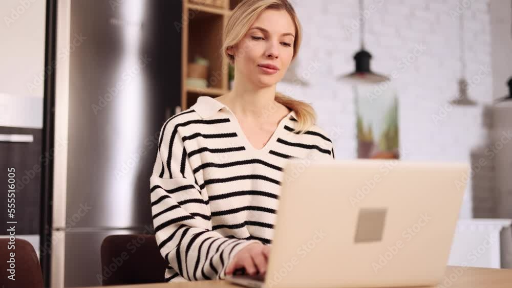 Pretty blond woman with cup of coffee working on laptop checking email surfing web at home workplace Young female student with online distance education or freelance project on computer indoors Pretty blond woman with cup of coffee working on laptop checking email surfing web at home workplace Young female student with online distance education or freelance project on computer indoors