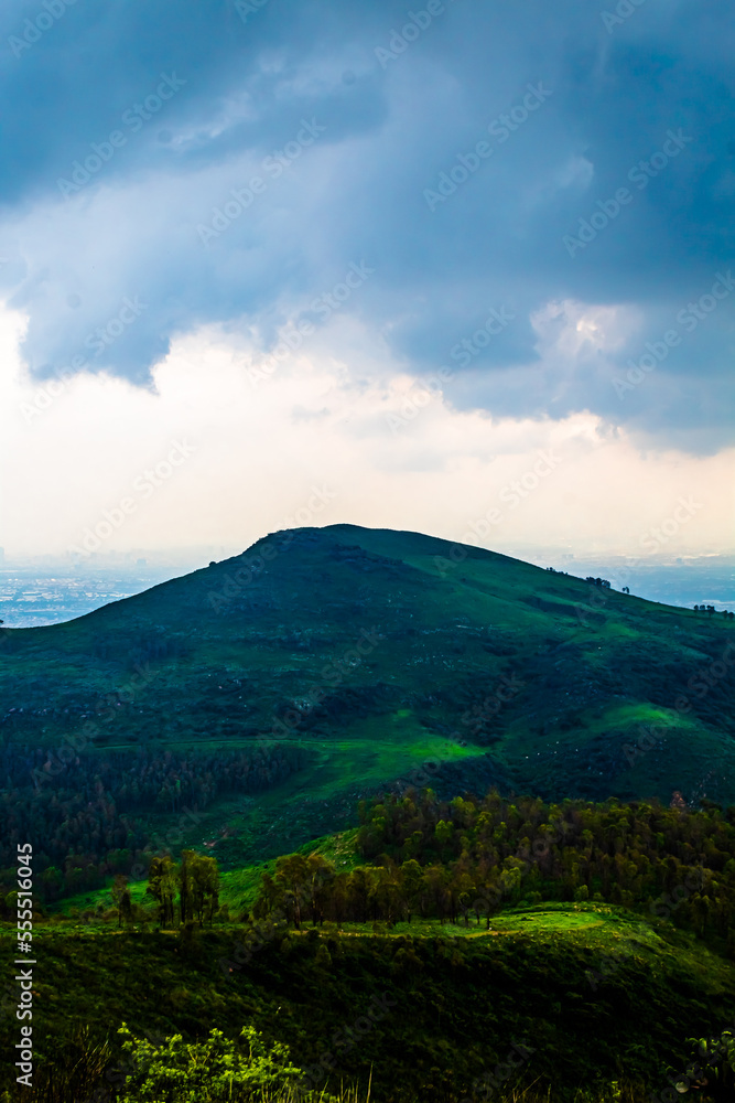 green mountain in summer with cloudy sky in sierra de guadalupe state of mexico and cdmx 