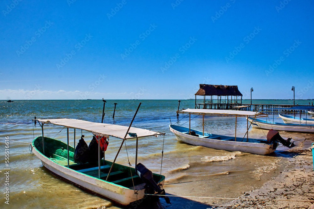 boats on the beach with blue sky, pier in isla aguada campeche, lagoon of terminos 