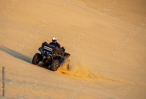 Quadbike bashing sand dunes in Doha, Qatar