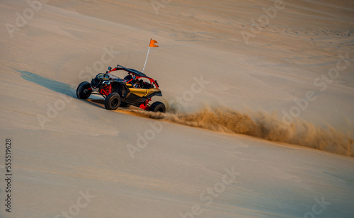 Fototapeta Naklejka Na Ścianę i Meble -  Custom made desert safari racer car bashing sand dunes in Doha, Qatar