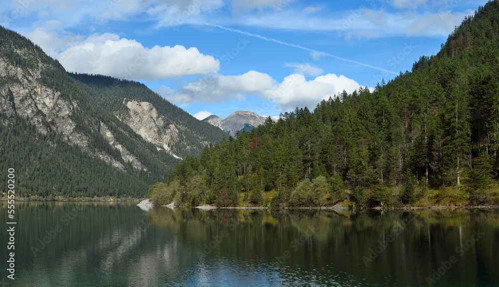 Scenic view of mountains and a clear lake (Plansee) in autumn, Tirol, Austria Scenic view of mountains and a clear lake (Plansee) in autumn, Tirol, Austria