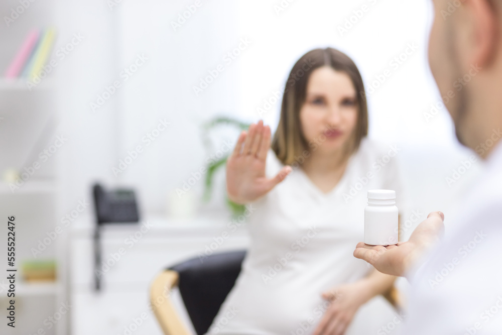 Photo of hand with medicine and blurred woman on the background. Photo of hand with medicine and blurred woman on the background.