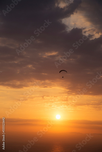 Silhouette of Parasailing at Sunset, Parque Raimondi along Malecon Cisneros, Miraflores, Lima, Peru photo