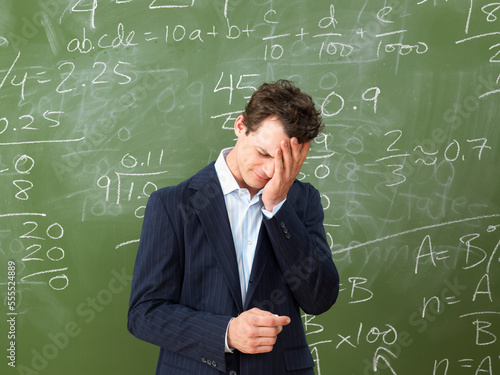 Teacher in Front of Blackboard photo