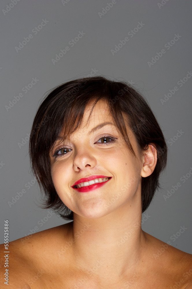 Head and Shoulders Portrait of Mid-Adult Woman with Grey Background Head and Shoulders Portrait of Mid-Adult Woman with Grey Background