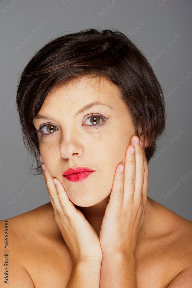 Head and Shoulders Portrait of Mid-Adult Woman with Grey Background Head and Shoulders Portrait of Mid-Adult Woman with Grey Background