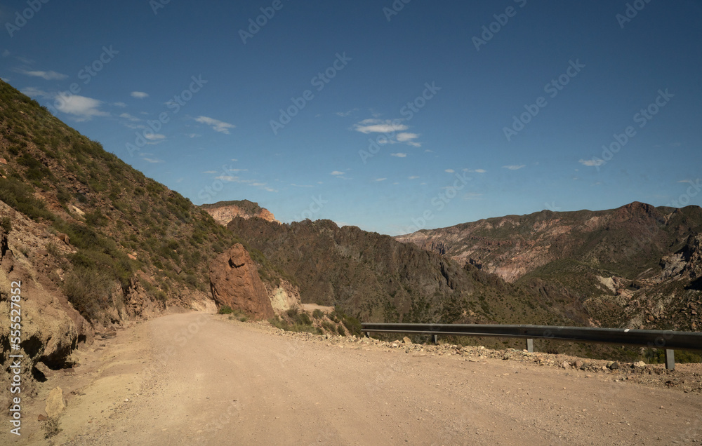 Travel. View of the dirt road across the arid desert and mountains. Travel. View of the dirt road across the arid desert and mountains.