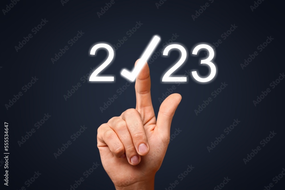 Businessman hand pointing on 2023 icon Businessman hand pointing on 2023 icon