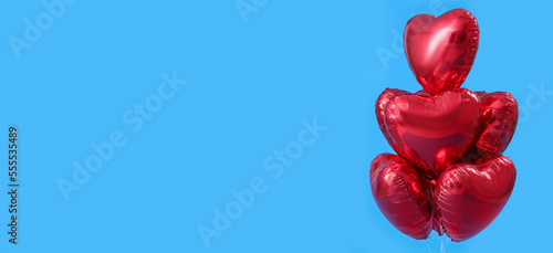 Beautiful heart-shaped balloons for Valentine s Day celebration on light blue background with space for text