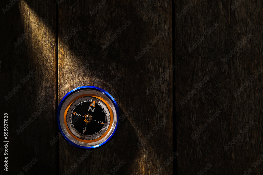 Compass on dark wooden background, top view Compass on dark wooden background, top view