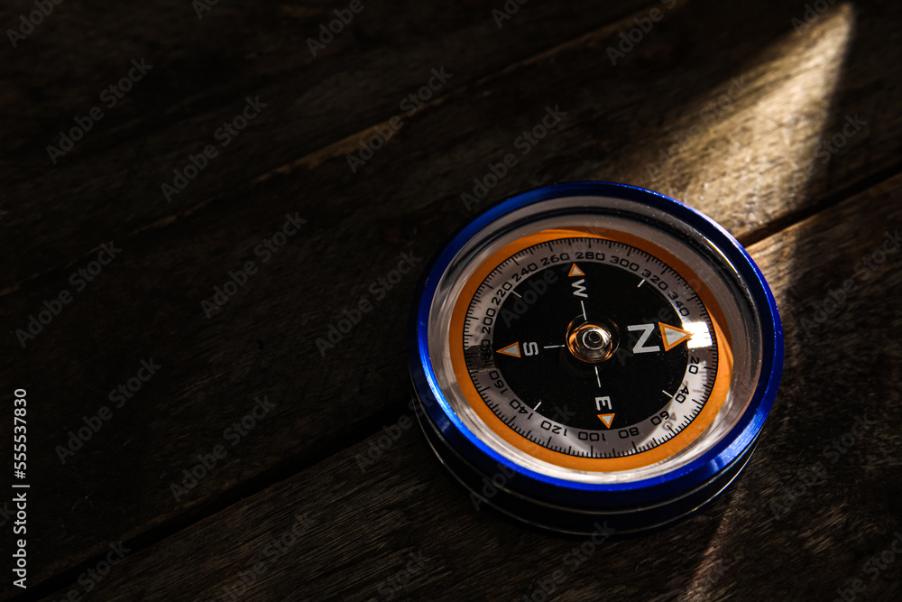 Compass on dark wooden background Compass on dark wooden background