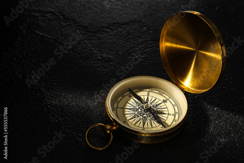 Golden compass on dark background
