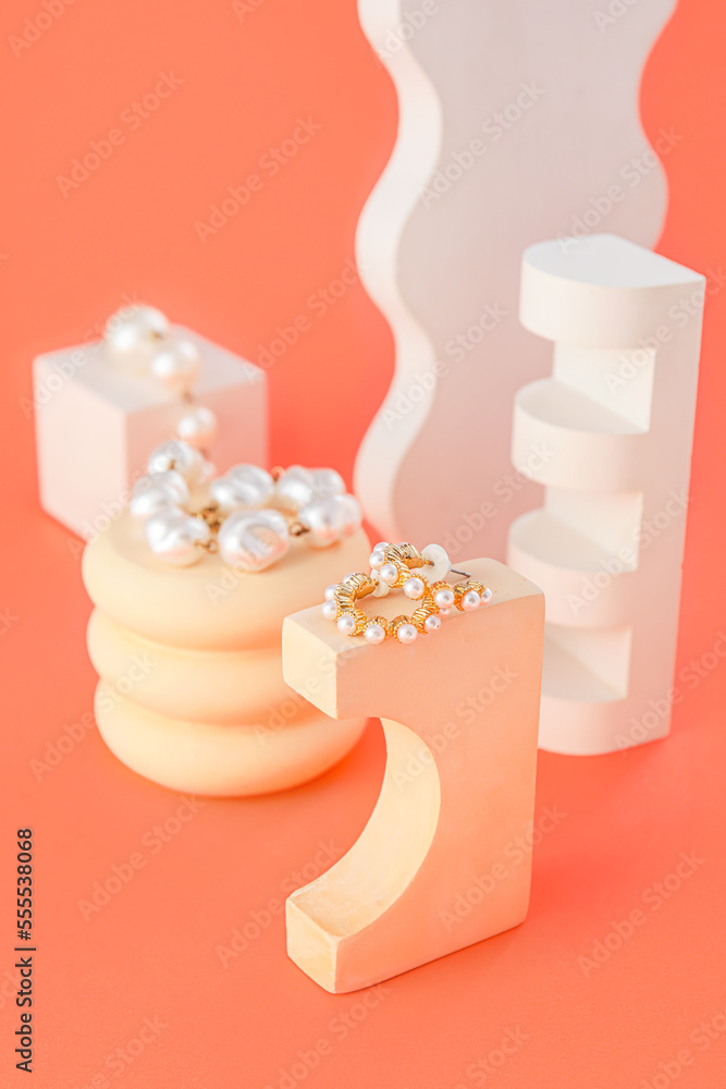 Stand with pearl jewelry on color background Stand with pearl jewelry on color background