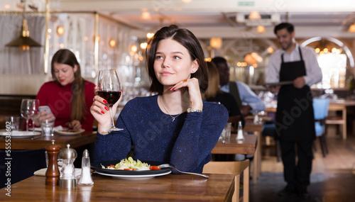 Woman is dining alone in luxurious restaurant.