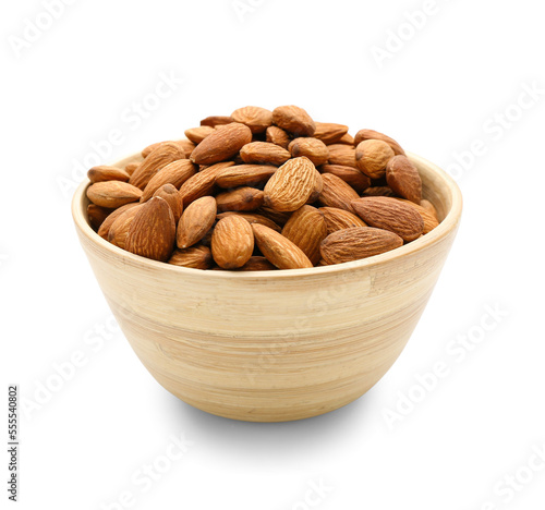 Wooden bowl of tasty almonds on white background