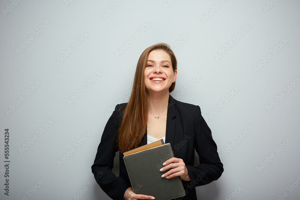 Smiling woman teacher or student holding book. Isolated portrait with copy space. Smiling woman teacher or student holding book. Isolated portrait with copy space.